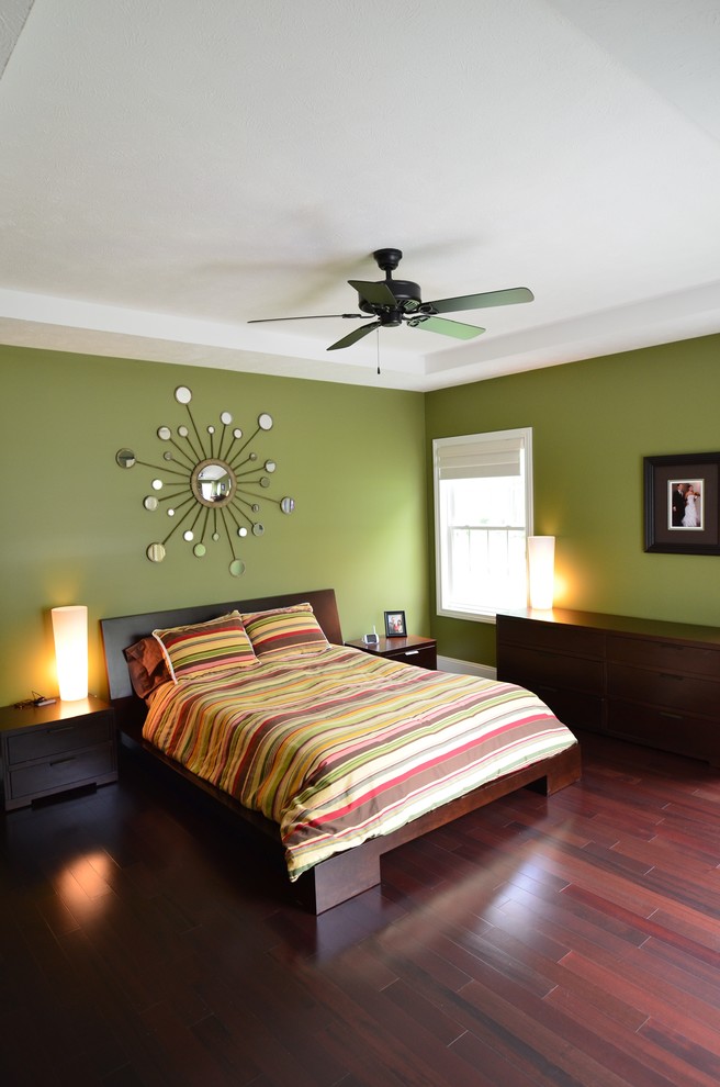 Inspiration for a medium sized traditional master bedroom in Cleveland with green walls, medium hardwood flooring and no fireplace.