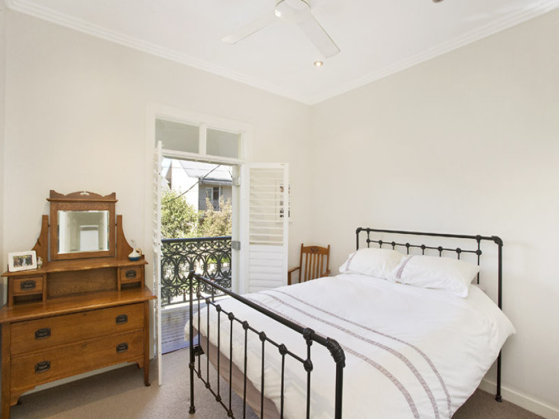Example of a small trendy master carpeted bedroom design in Sydney with beige walls