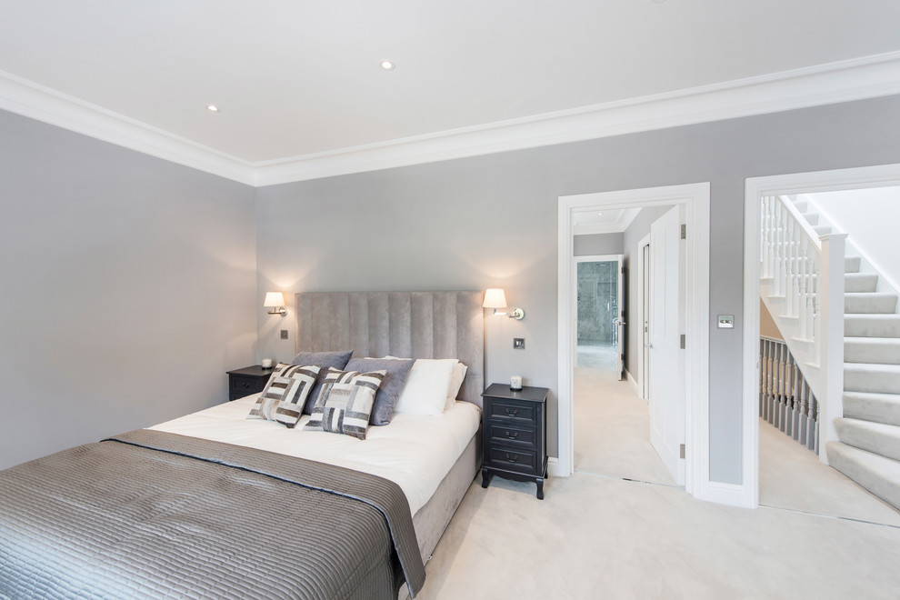 This is an example of a large contemporary master bedroom in London with no fireplace, grey walls, carpet and beige floors.