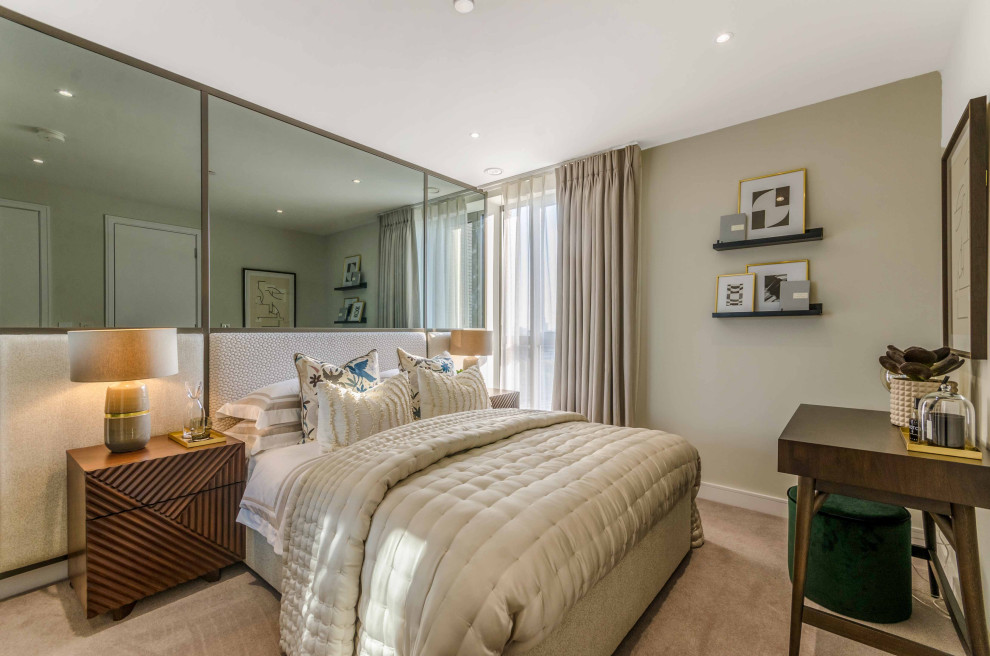 Medium sized contemporary master bedroom in London with carpet and grey floors.