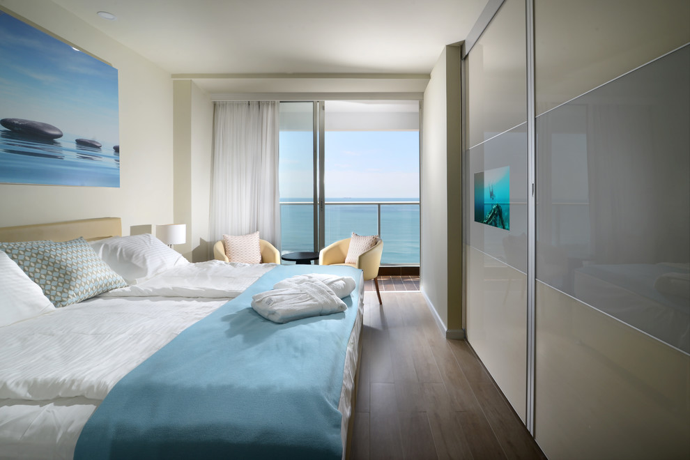 Inspiration for a medium sized coastal guest bedroom in Tel Aviv with beige walls, plywood flooring and no fireplace.