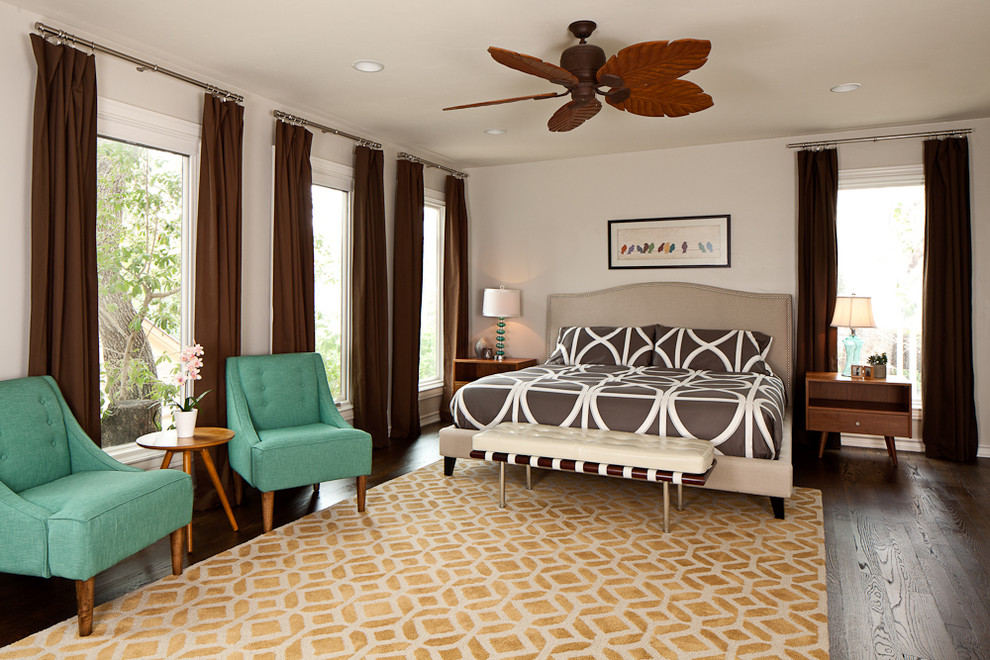 Modern bedroom in Austin with white walls and dark hardwood flooring.