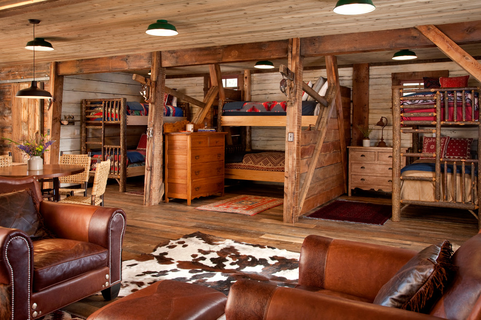 Example of a mountain style loft-style bedroom design in Other