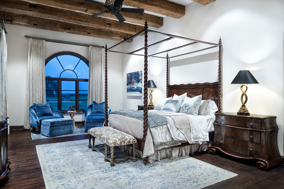 This is an example of a large mediterranean master bedroom in Austin.