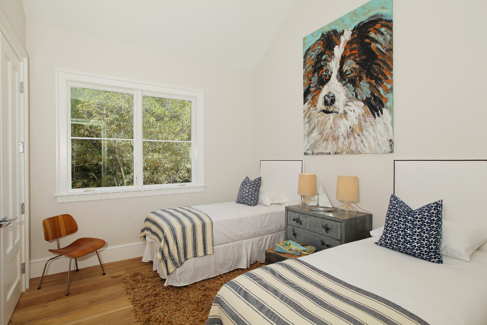 Elegant guest medium tone wood floor bedroom photo in Los Angeles with white walls and no fireplace