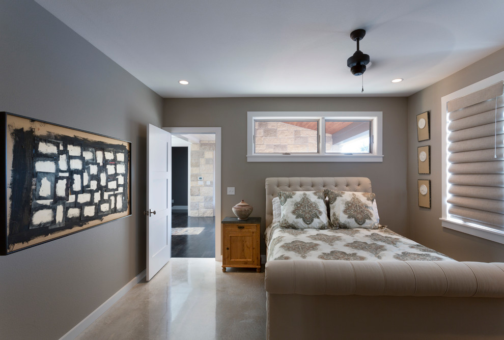 This is an example of a medium sized classic guest bedroom in Austin with grey walls, concrete flooring and no fireplace.