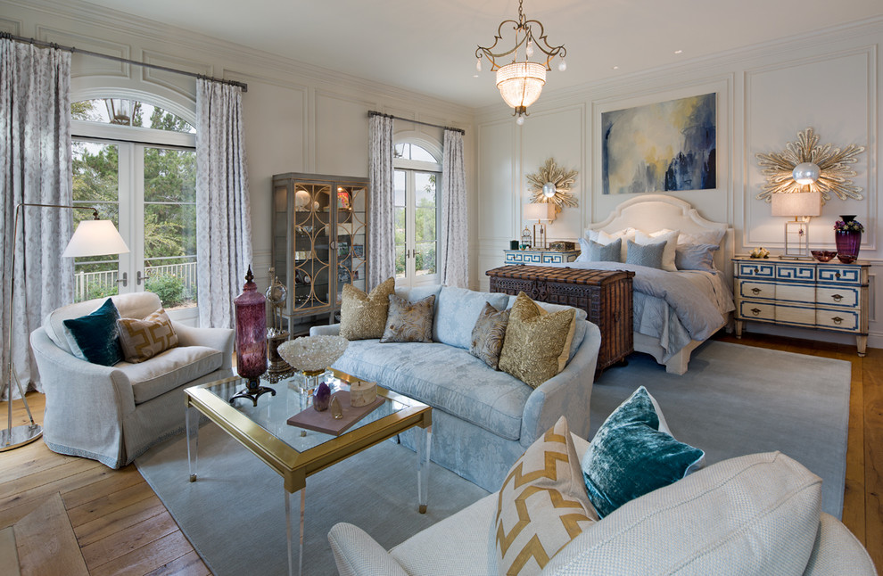 Large mediterranean bedroom in San Diego with white walls and light hardwood flooring.