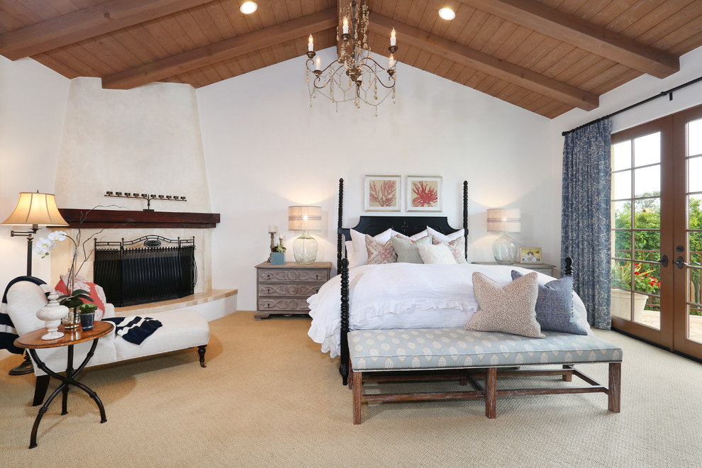 Design ideas for a mediterranean bedroom in Orange County with white walls, carpet and a corner fireplace.