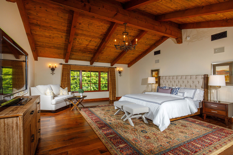 Esempio di una camera da letto stile americano con pareti bianche, pavimento in legno massello medio e pavimento marrone