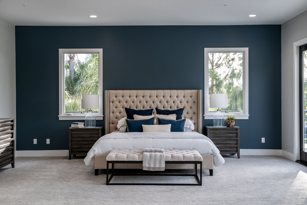 Inspiration for an expansive mediterranean master bedroom in San Diego with blue walls, carpet, a standard fireplace, a tiled fireplace surround and grey floors.