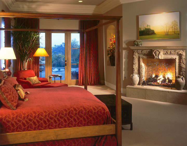 This is an example of a classic master bedroom in San Diego with a standard fireplace.