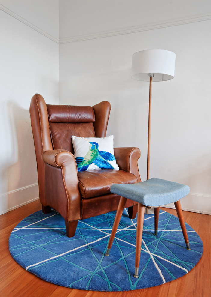 Small eclectic master medium tone wood floor bedroom photo in Sydney with white walls