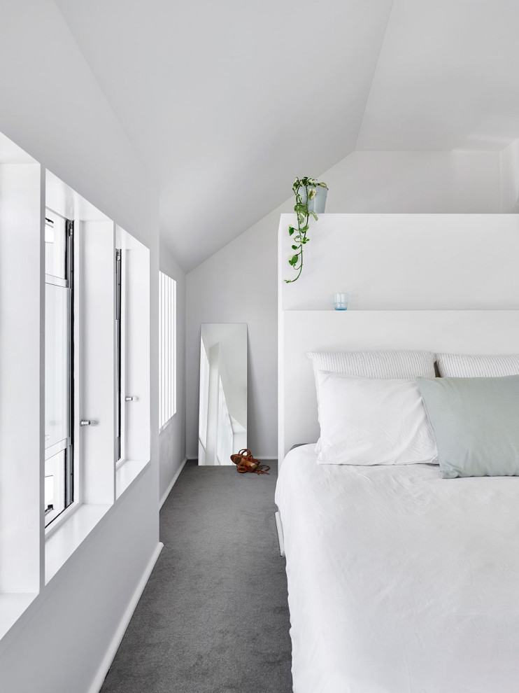 Contemporary bedroom in Brisbane with white walls, carpet, grey floors and a vaulted ceiling.