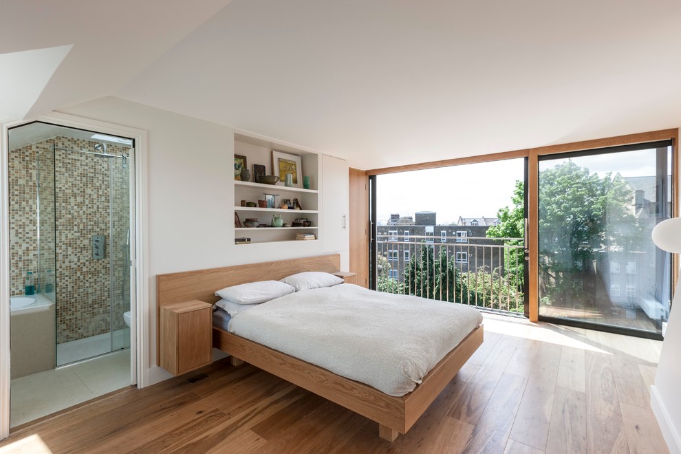 Large contemporary master bedroom in London with white walls.