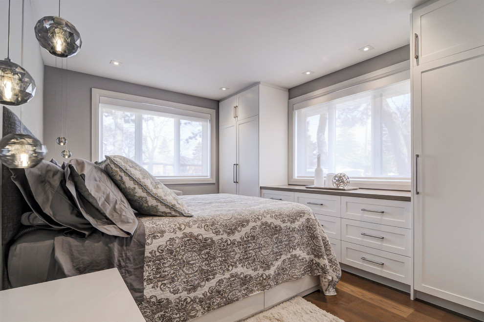 Example of a large transitional master dark wood floor and brown floor bedroom design in Toronto with gray walls and no fireplace