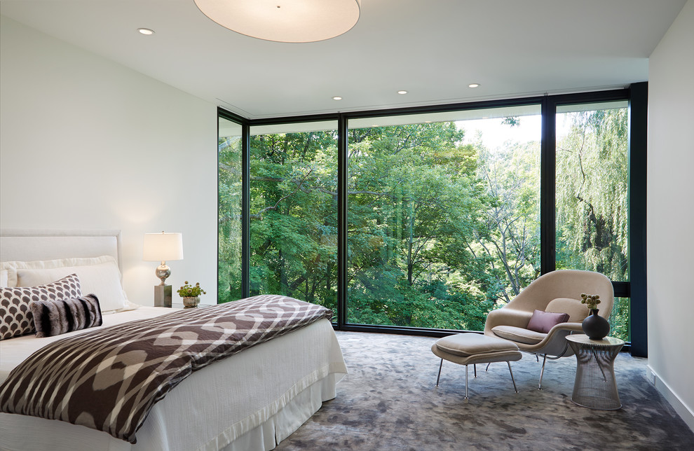 Modern master bedroom in Chicago with white walls, carpet and grey floors.