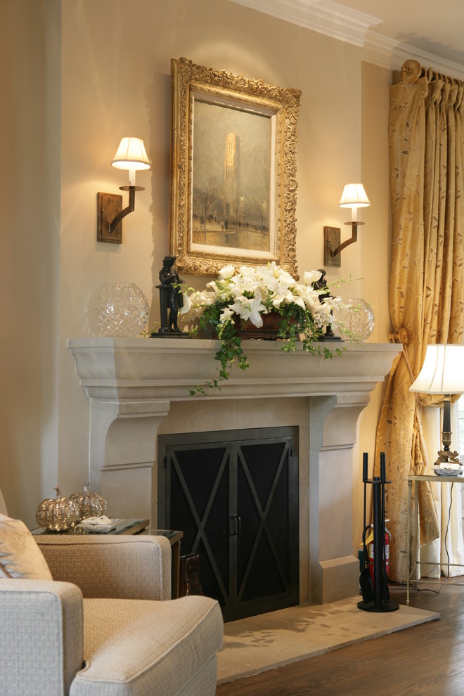 This is an example of a traditional bedroom in Los Angeles with a standard fireplace, beige walls and a chimney breast.