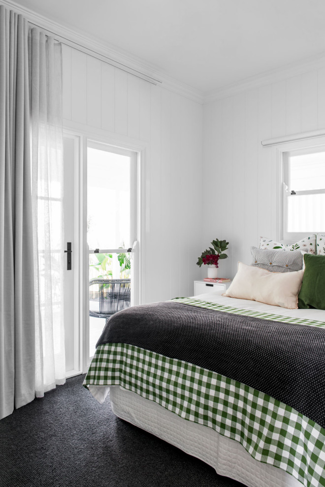This is an example of a small traditional guest bedroom in Brisbane with white walls, carpet and grey floors.