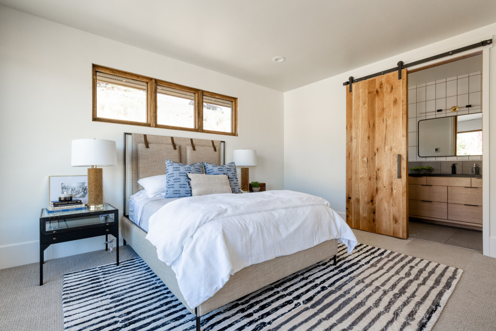 Photo of a rustic bedroom in Salt Lake City with white walls, carpet and grey floors.