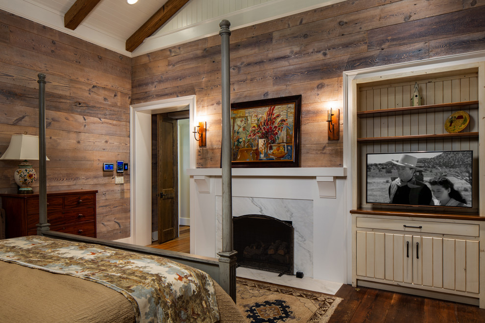 Design ideas for a medium sized rustic master bedroom in Birmingham with brown walls, dark hardwood flooring, a standard fireplace, a concrete fireplace surround and brown floors.