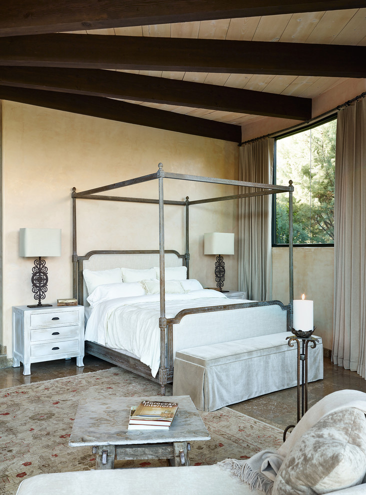 Tuscan master bedroom photo in Phoenix with beige walls
