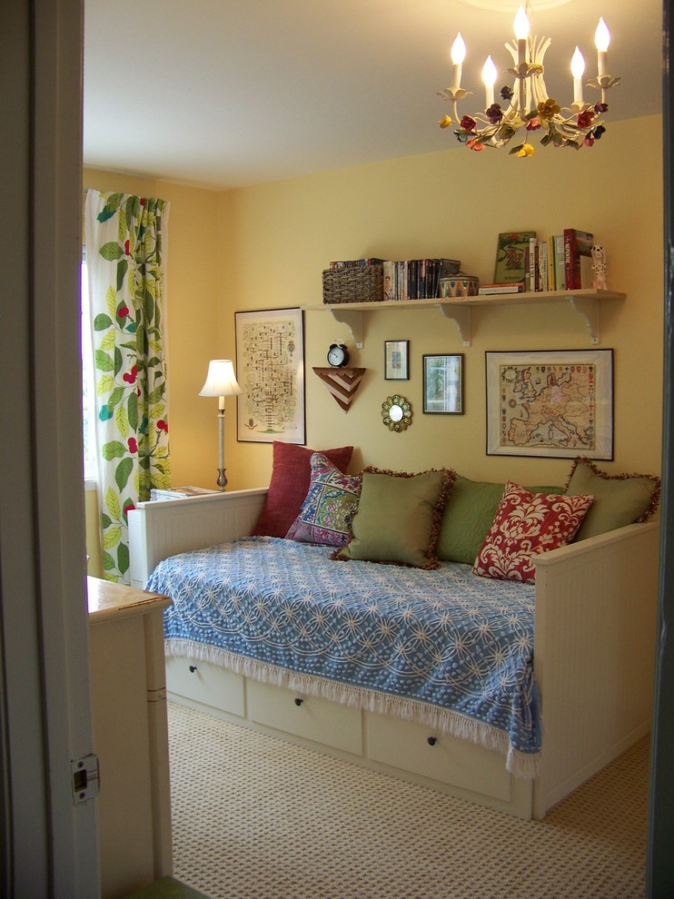 This is an example of a traditional guest bedroom in San Diego with yellow walls, carpet and no fireplace.