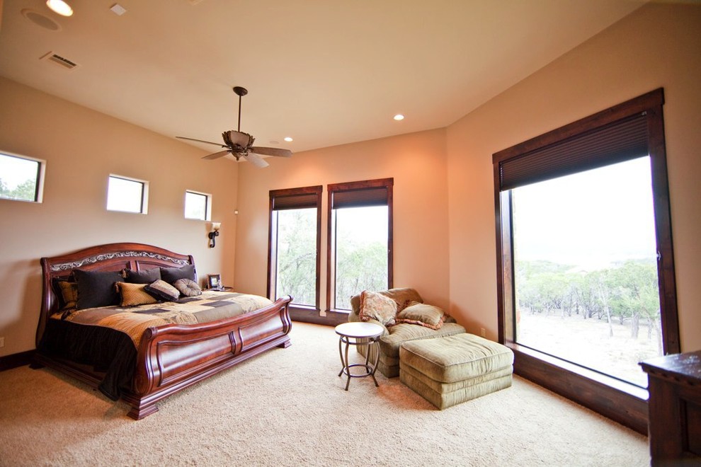 Photo of a traditional master bedroom in Austin with beige walls, carpet, beige floors and no fireplace.