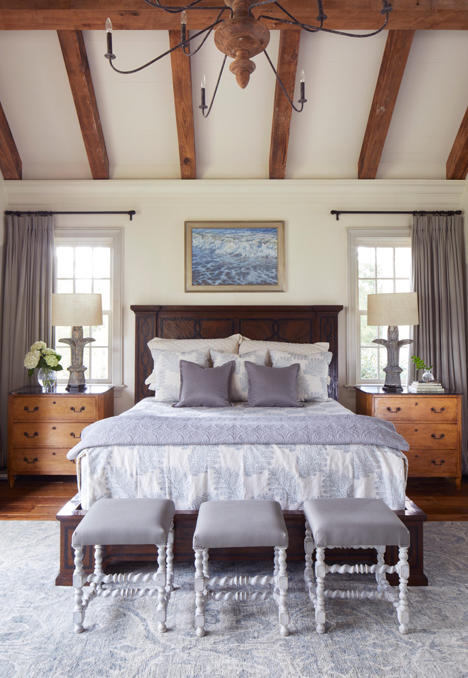Beach style medium tone wood floor and brown floor bedroom photo in Other with white walls