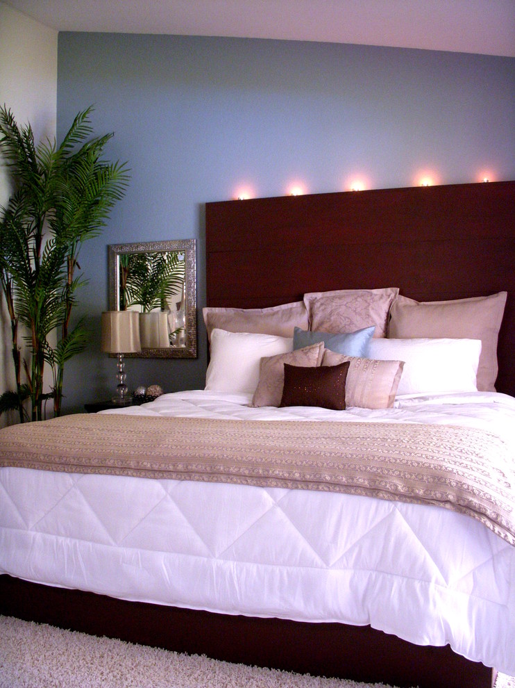Example of a mid-sized island style master carpeted bedroom design in Seattle with blue walls