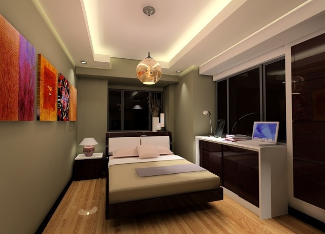 Immagine di una piccola camera da letto minimal con pareti verdi e parquet chiaro