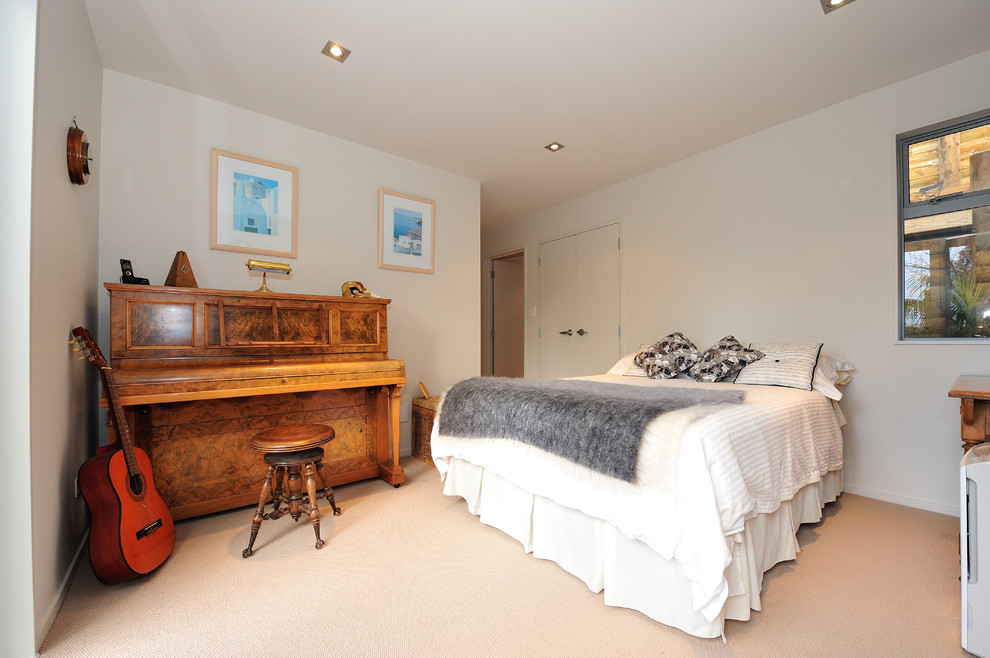 Photo of a medium sized contemporary guest bedroom in Auckland with white walls and carpet.