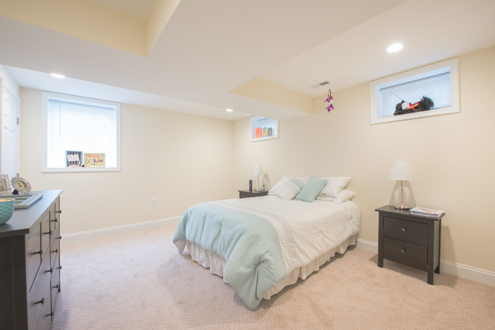 This is an example of a medium sized retro guest bedroom with beige walls, carpet and beige floors.