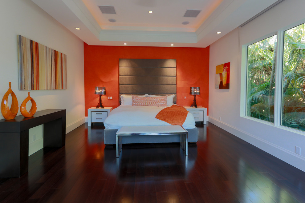 Example of a mid-sized minimalist master dark wood floor bedroom design in Miami with white walls