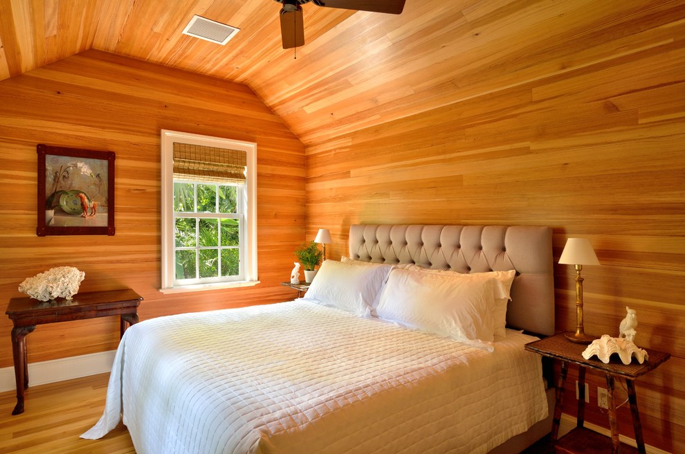 Mid-sized island style guest medium tone wood floor bedroom photo in Miami with no fireplace and multicolored walls