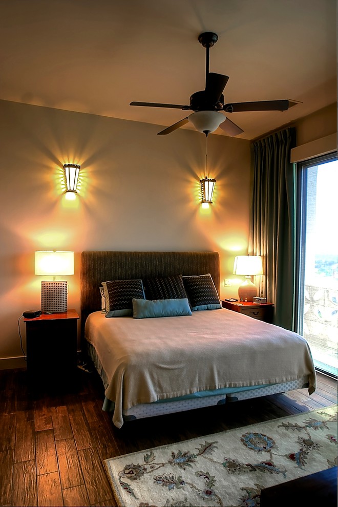 Inspiration for a mid-sized modern master medium tone wood floor bedroom remodel in Austin with beige walls and no fireplace