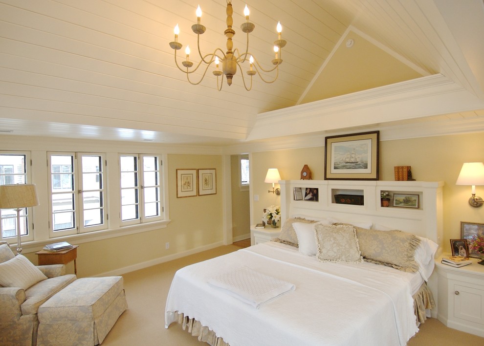 This is an example of a large traditional master bedroom in Minneapolis with beige walls and carpet.