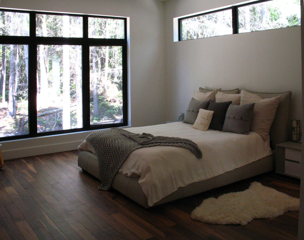 Design ideas for a large contemporary master bedroom in Montreal with white walls and dark hardwood flooring.