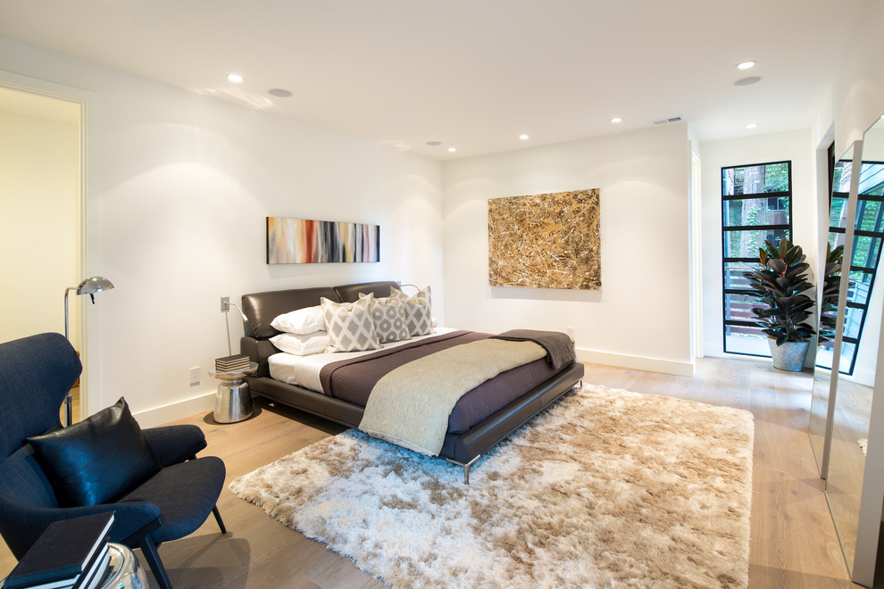 Inspiration for a contemporary master light wood floor and beige floor bedroom remodel in DC Metro with white walls