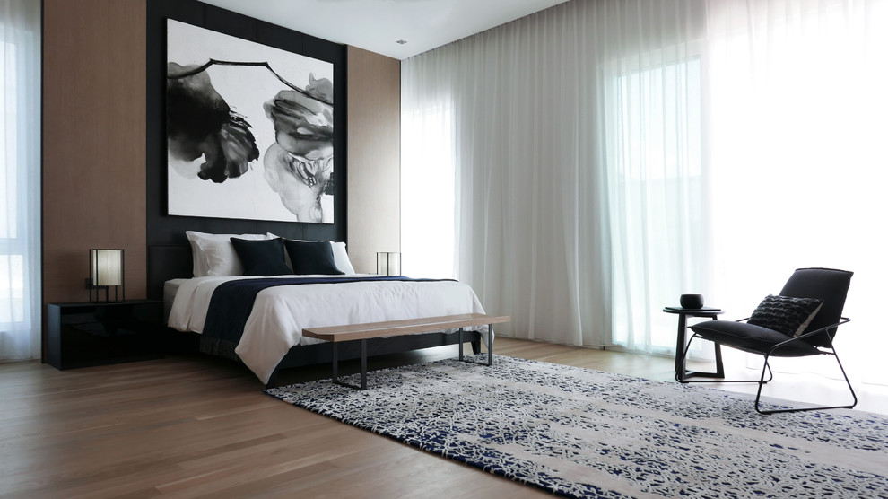 Photo of a large contemporary bedroom in Singapore with medium hardwood flooring.