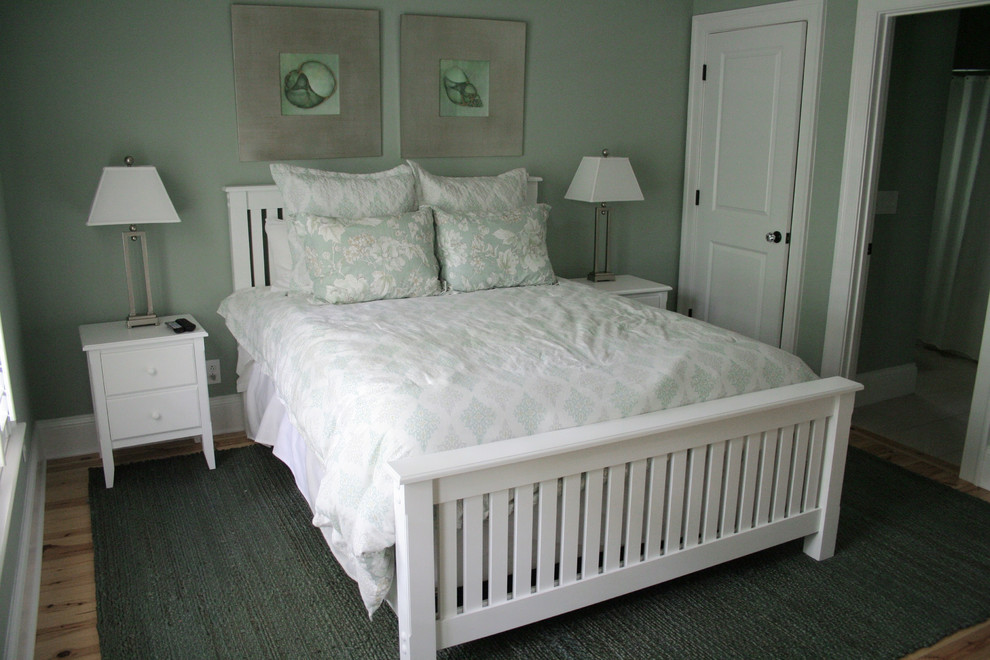 Photo of a medium sized classic guest bedroom in Charleston with green walls and light hardwood flooring.