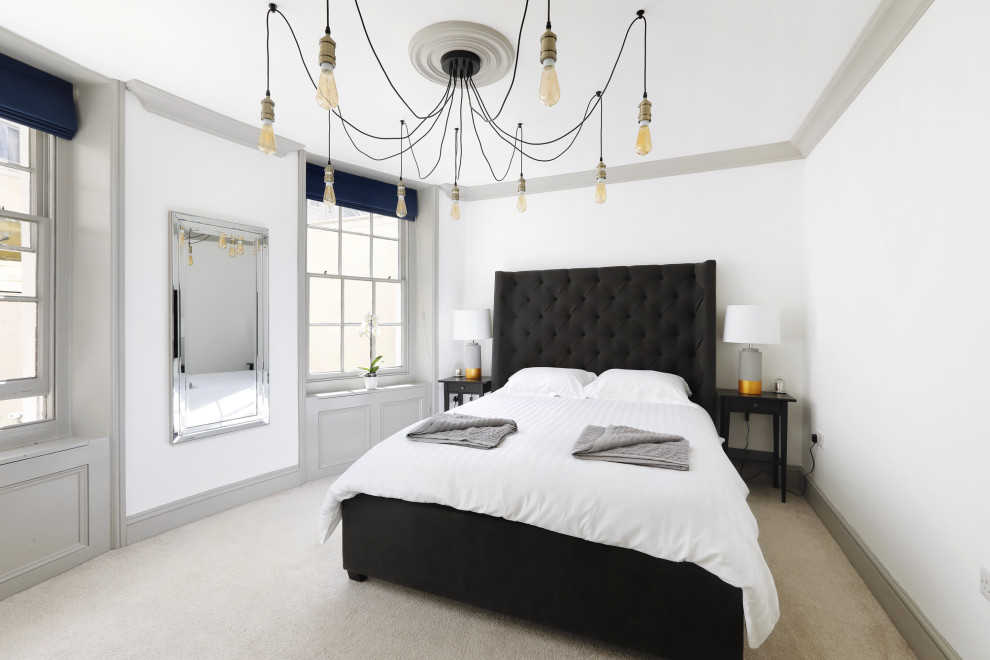 Esempio di una camera matrimoniale design di medie dimensioni con pareti bianche, moquette e pavimento beige