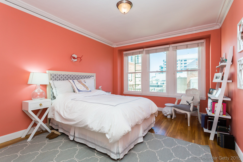 This is an example of a medium sized traditional master bedroom in San Francisco with medium hardwood flooring and pink walls.