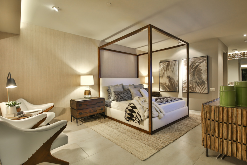 Inspiration for a large world-inspired guest bedroom in Los Angeles with beige walls, no fireplace, porcelain flooring, a stone fireplace surround, beige floors and feature lighting.
