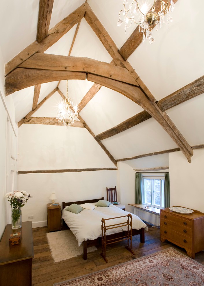 Bedroom - mid-sized traditional master medium tone wood floor bedroom idea in Other with white walls and no fireplace