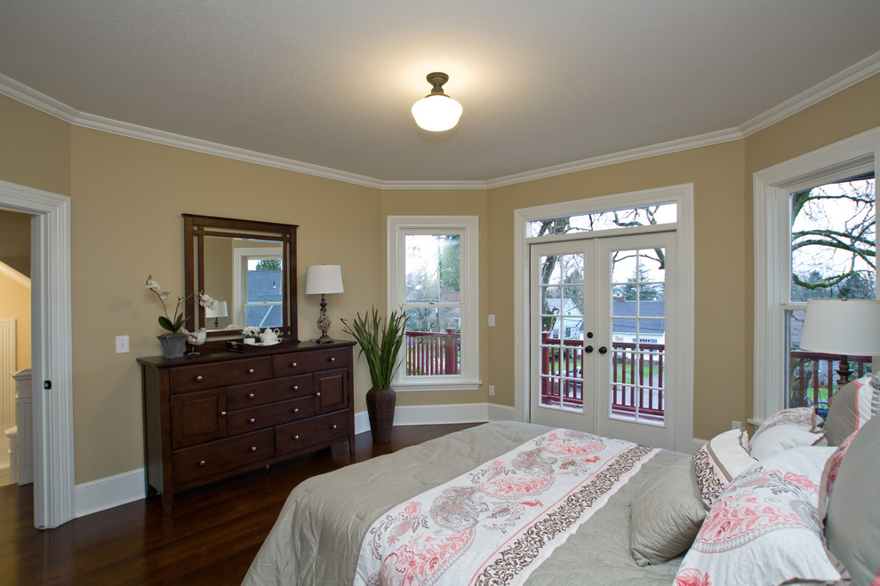 Example of a mid-sized classic master medium tone wood floor bedroom design in Portland with beige walls and no fireplace