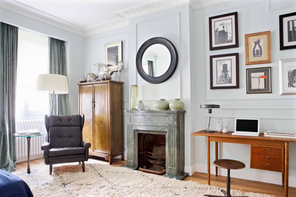 Bedroom - large transitional master medium tone wood floor bedroom idea in Other with a standard fireplace