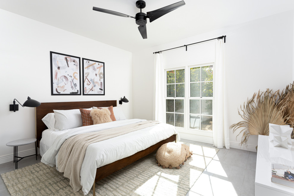 Photo of a contemporary bedroom in Phoenix with white walls and grey floors.