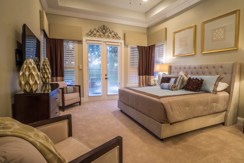 Traditional master bedroom in Orlando with beige walls and carpet.