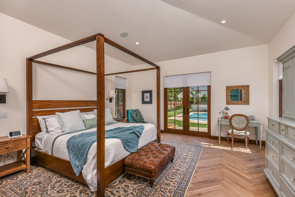 Example of a large tuscan master medium tone wood floor and brown floor bedroom design in Orlando with white walls