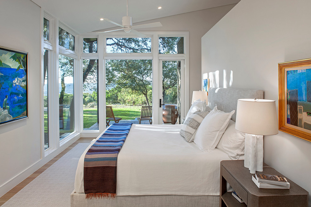 Diseño de dormitorio principal clásico renovado de tamaño medio con paredes blancas y suelo de madera clara